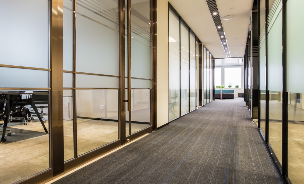 Glass-fronted office interiors and a bright corridor